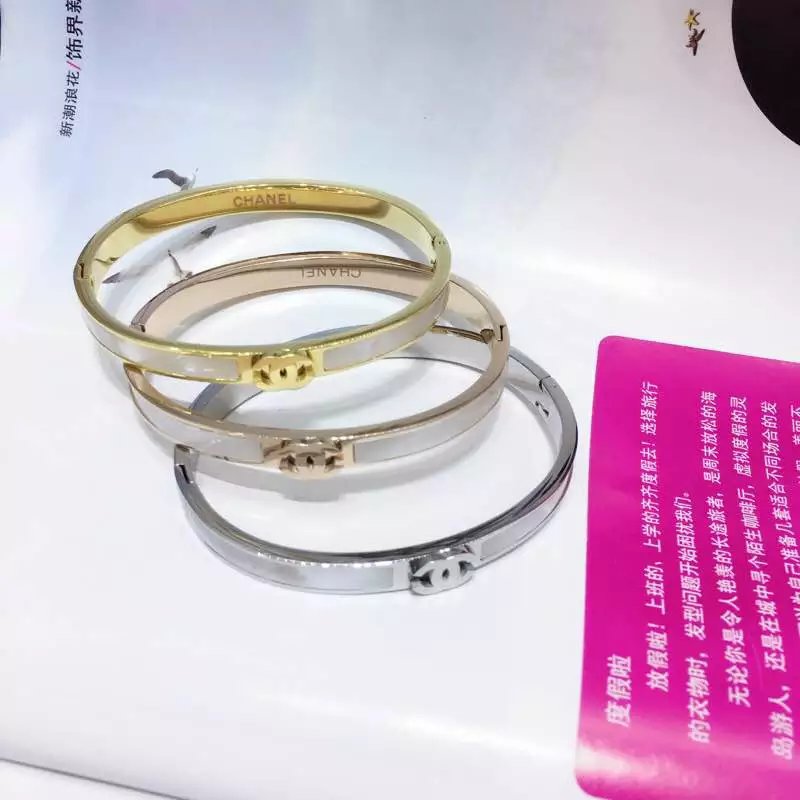 Chanel CC Logo Hinged Bangle bracelet Gold-tone metal with white mother-of-pearl inlay Rose gold-tone metal with white mother-of-pearl inlay Silver-tone metal with white enamel inlay 17cm inner circumference