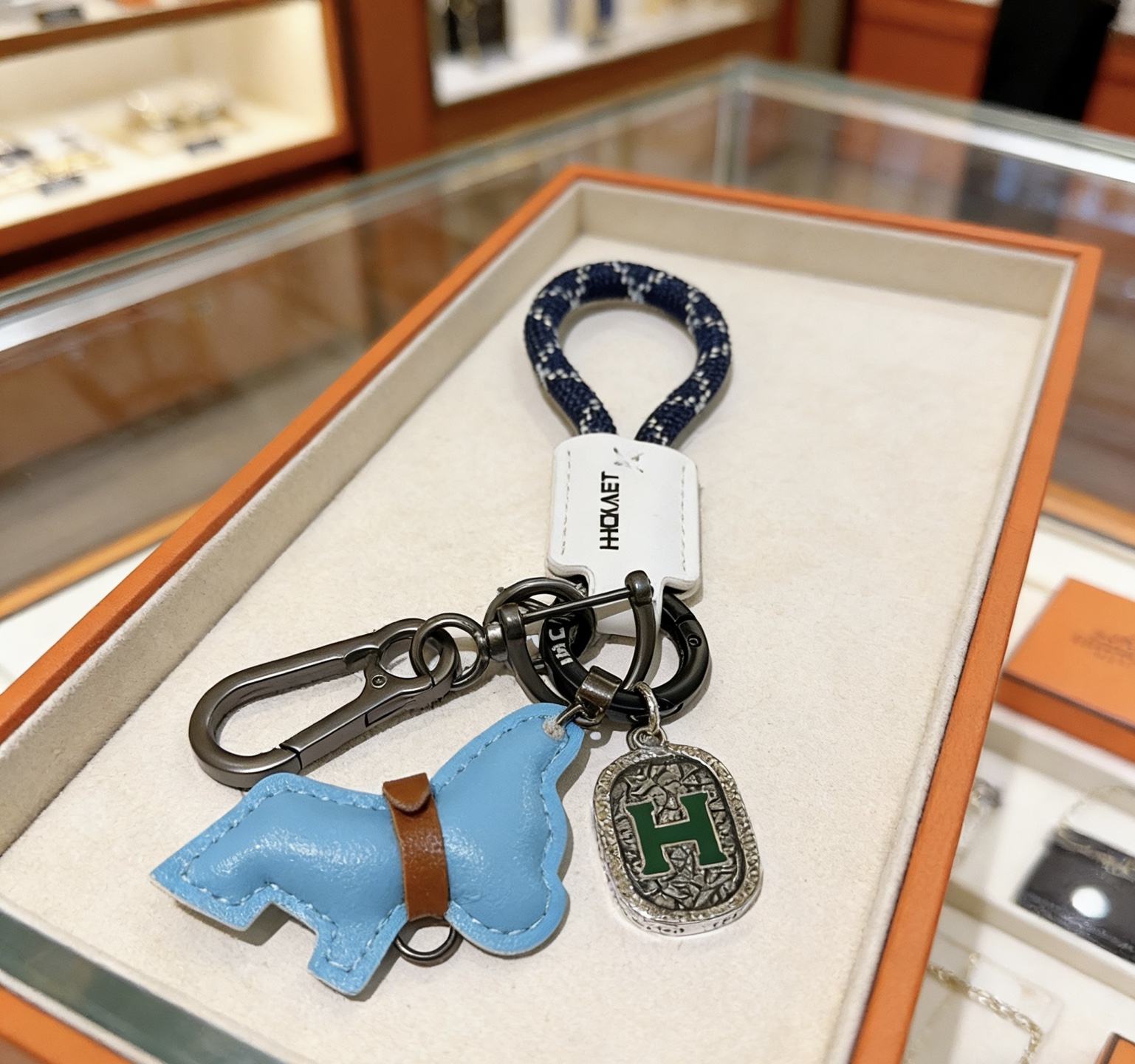 Hermes H Logo Horse Charm Porte-clés pendentif Matériel en bronze à canon corde tressée bleu marine avec accents blancs étiquette en cuir blanc breloque cheval en cuir bleu clair avec bracelet en cuir marron breloque en argent antique avec émail H vert longueur totale 10 cm