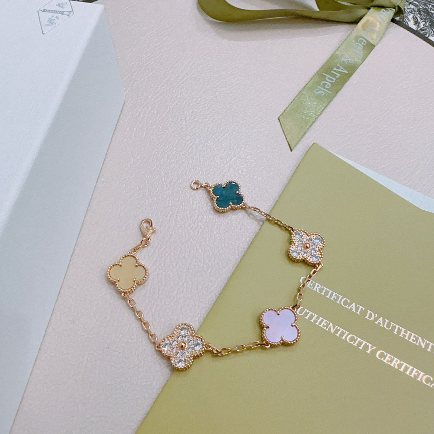 Van Cleef Arpels Alhambra bracelet Rose gold metal with white mother-of-pearl teal agate champagne mother-of-pearl opal and clear diamond accents 17cm
