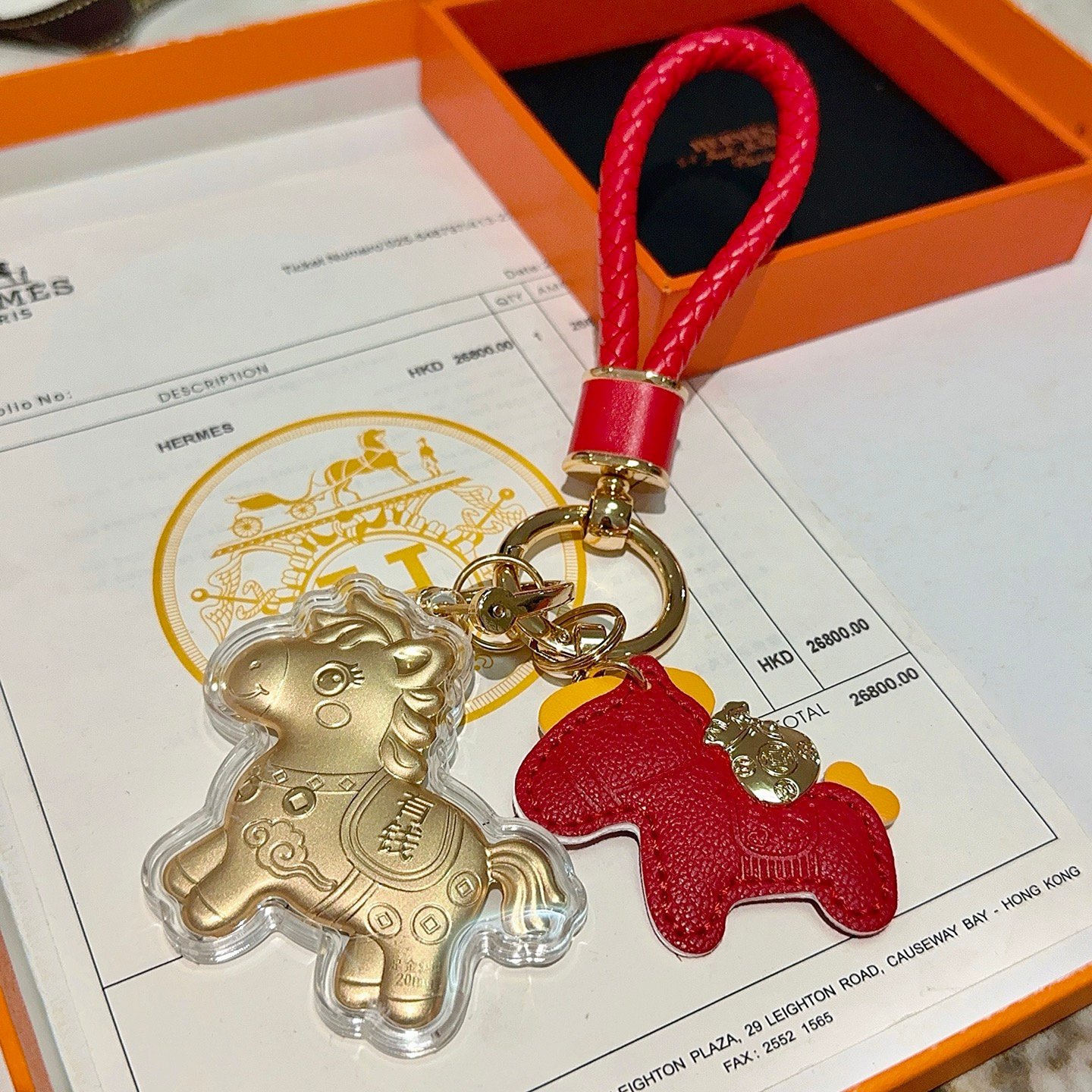 Hermes Rodeo Wealth Horse Keychain Charm pendant Red braided leather gold-tone metal matte gold horse charm with clear protective casing yellow leather accents 12cm total length