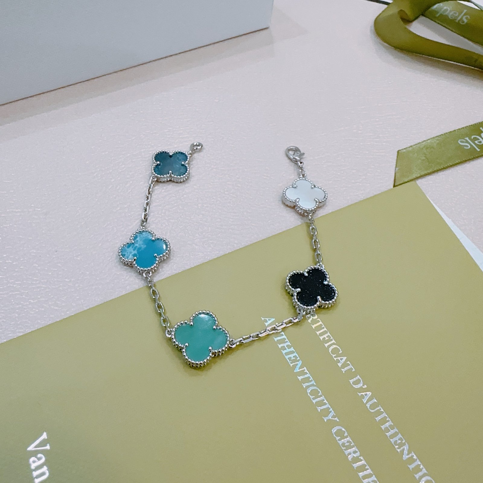 Van Cleef Arpels Alhambra bracelet Silver-toned metal with white mother-of-pearl black onyx turquoise blue agate and dark teal chalcedony clover motifs 17cm