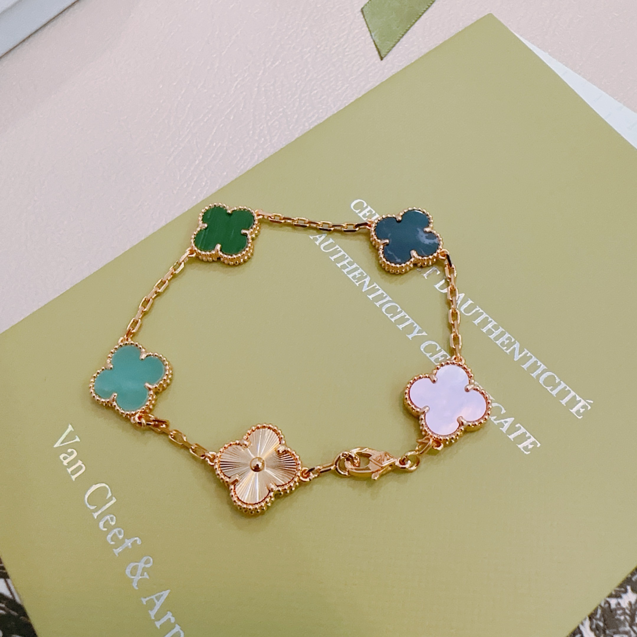 Van Cleef Arpels Alhambra bracelet Rose gold metal with green malachite dark blue stone turquoise white mother-of-pearl and guilloche rose gold clover motifs 19cm