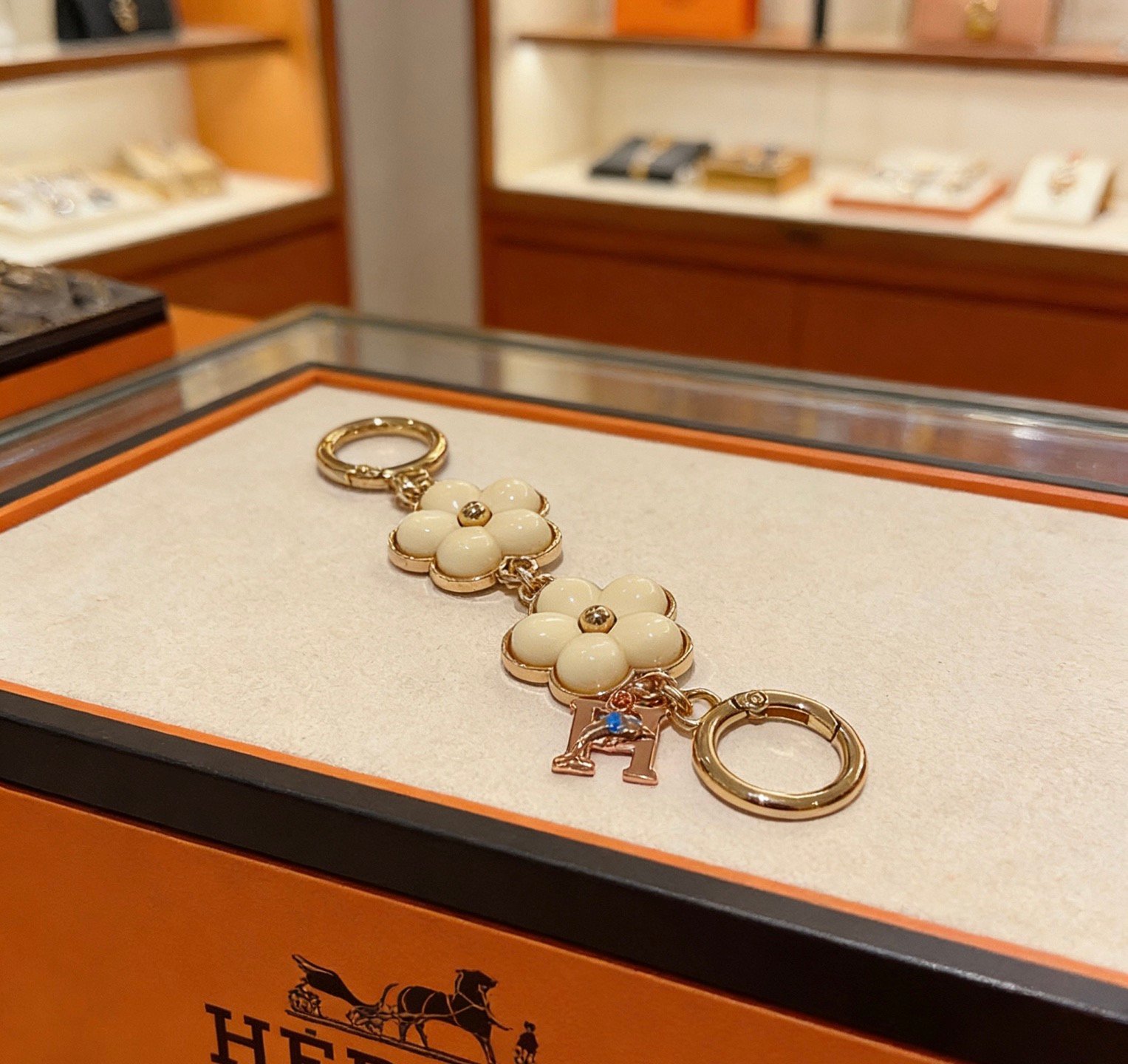 Hermes Flower H Logo Bag Charm Key Holder pendant Gold-tone metal with cream white enamel flower accents rose gold H charm with blue enamel detail 8cm total length